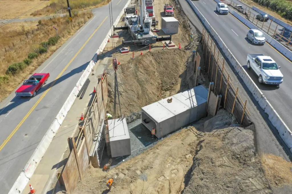 Aerial view of Ghilotti crew installing box culvert during highway project