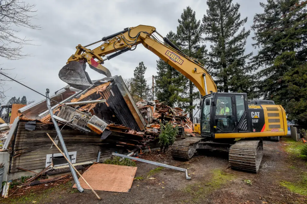 Ghilotti crew member uses a hydraulic excavator during residential demolition project